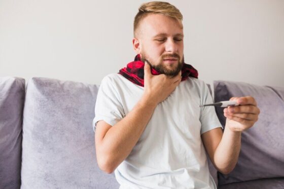 man scarf holding hand neck