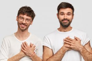 people and gratitude concept thankful two man students happy to recieve good marks for exam has beard and mustache dressed in casual white t shirt