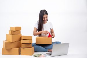 happy woman who are packing boxes online sales online work concept