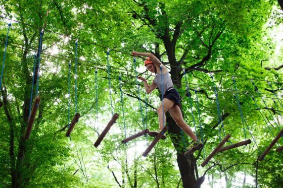 man steps wooden blocks hanging