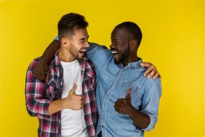 european and african man smiling and showing thumb to each other