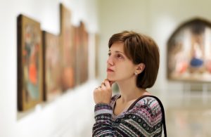 visitor looking pictures in art gallery